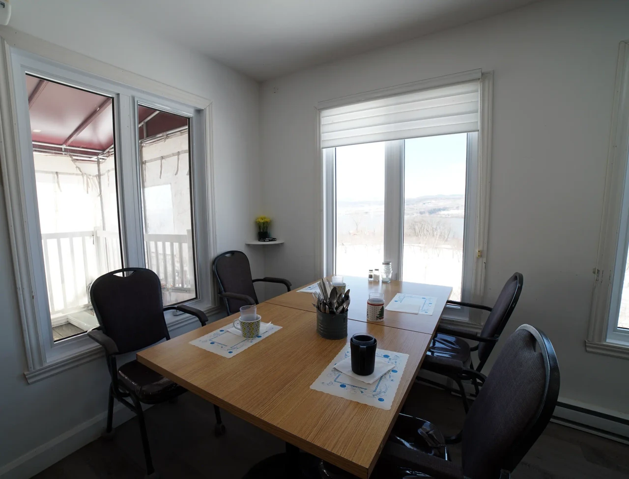 Une table de la salle à manger de la Résidence Sainte-Famille, près des grandes fenêtres